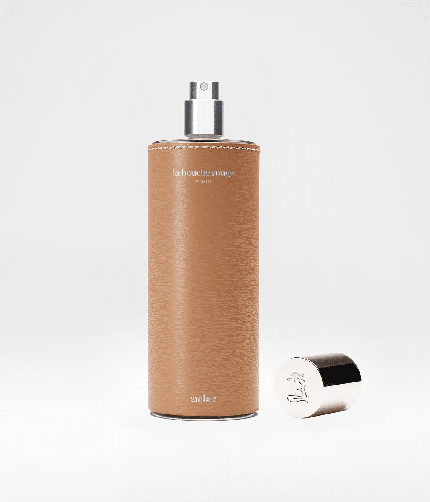 Flacon ouvert d'extrait de parfum Ambre La Bouche Rouge Paris, bouteille de 100ml avec bouchon doré et design élégant.