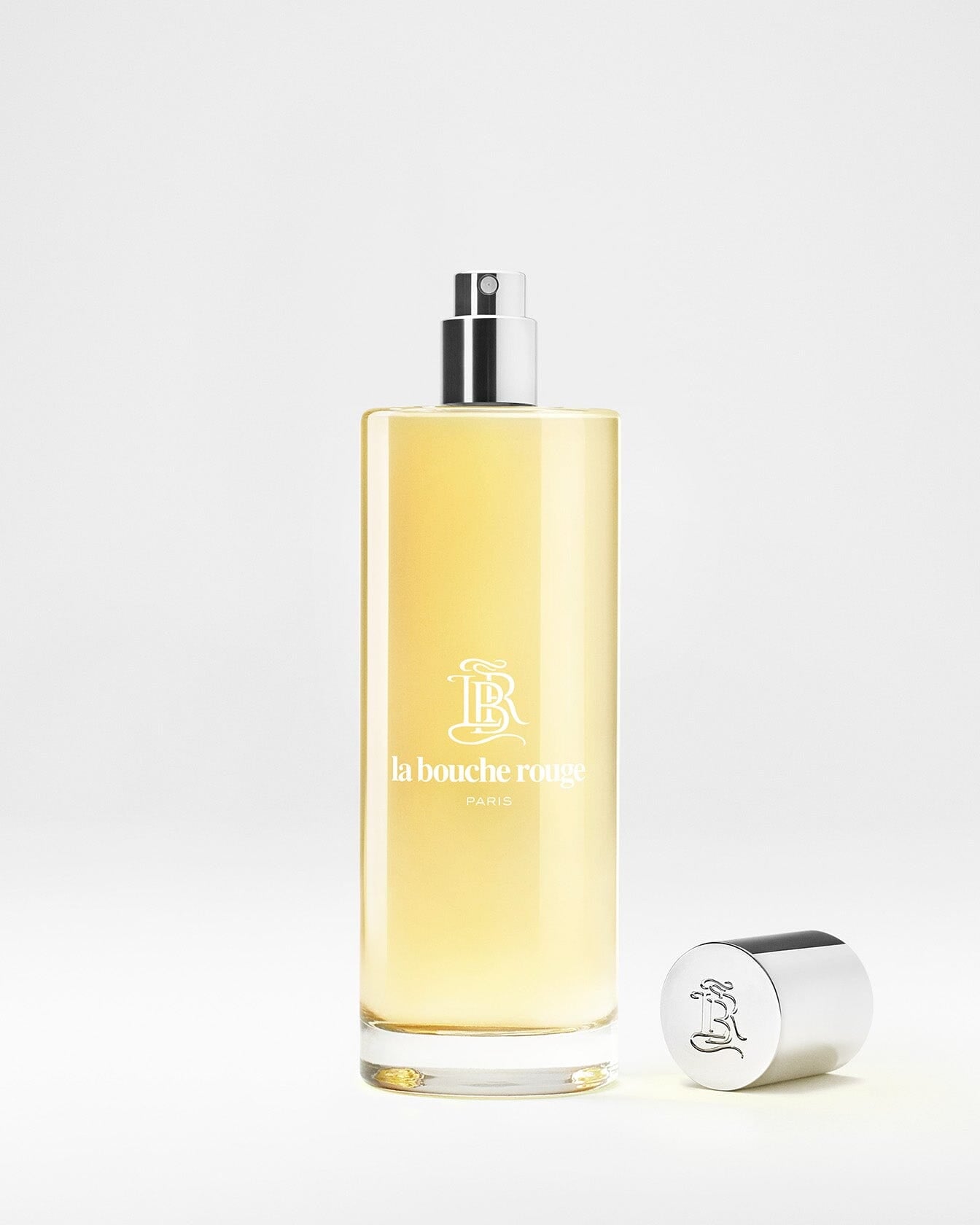 Flacon de parfum Capri Lumière Jaune de La Bouche Rouge Paris, eau de parfum, avec design élégant et étiquette jaune.