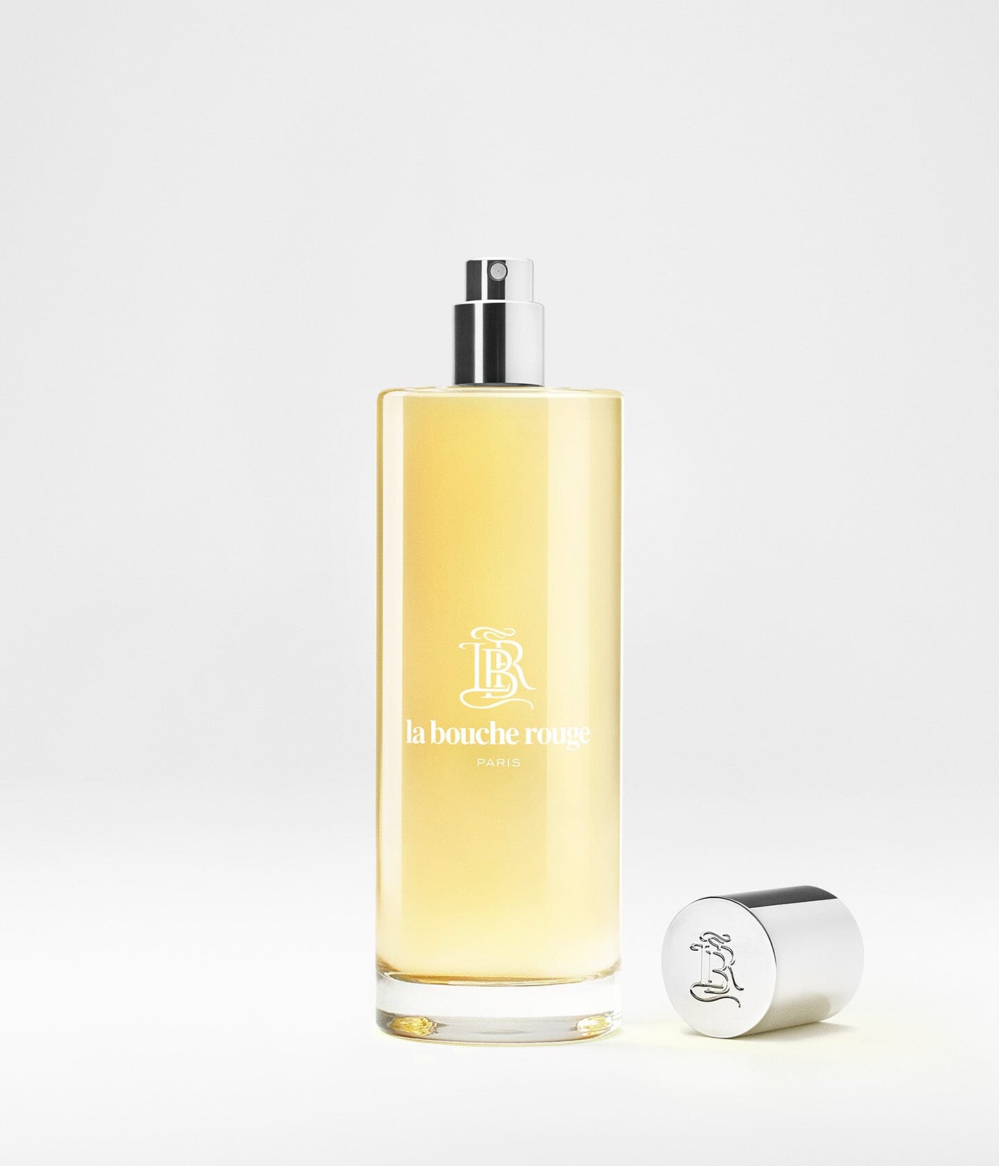 Flacon de parfum Capri Lumière Jaune de La Bouche Rouge Paris, eau de parfum, avec design élégant et étiquette jaune.