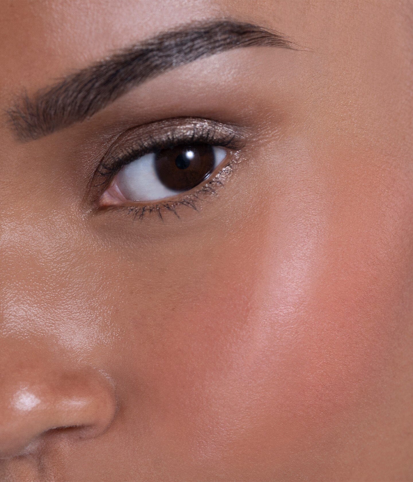 Blush solaire La Bouche Rouge Paris en teinte abricot et corail, présenté sur un bureau avec application douce visible.
