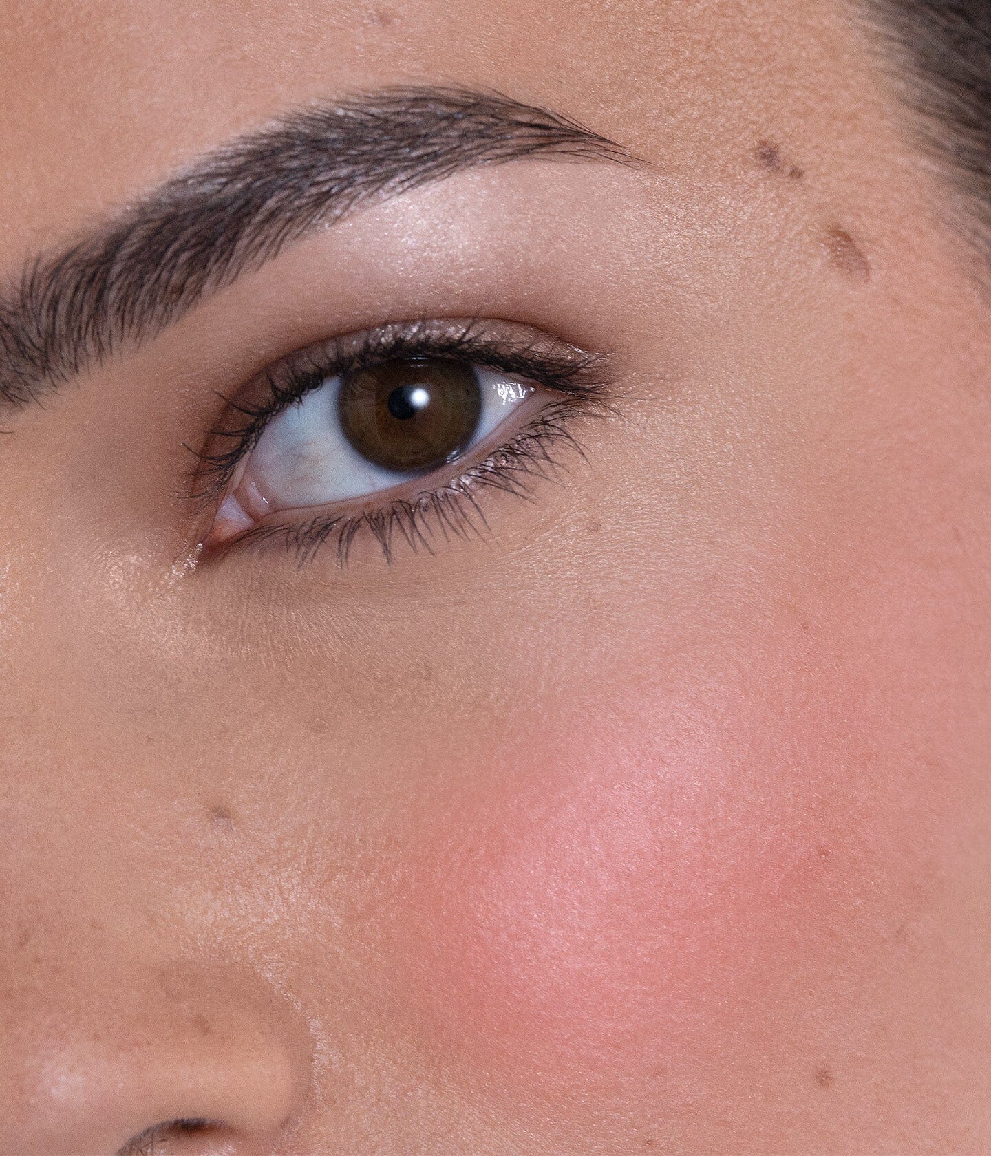 Accord lumineux Rose Pop et Dewy Pink de La Bouche Rouge Paris, blush crème sur un bureau avec un pinceau.