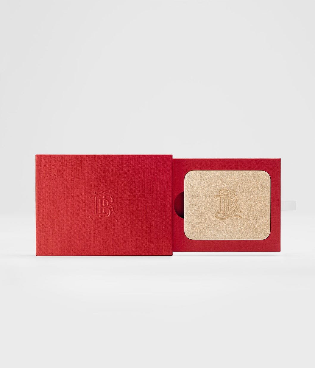 Poudre enlumineur La Lumière de La Bouche Rouge Paris, finition naturelle, visible dans son flacon élégant avec packaging minimaliste.