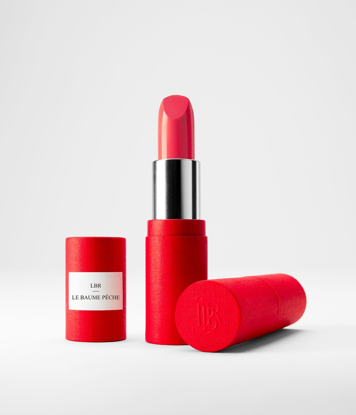 Baume à lèvres La Bouche Rouge Paris, soin des lèvres avec recharge à la pêche, texture douce et hydratante.