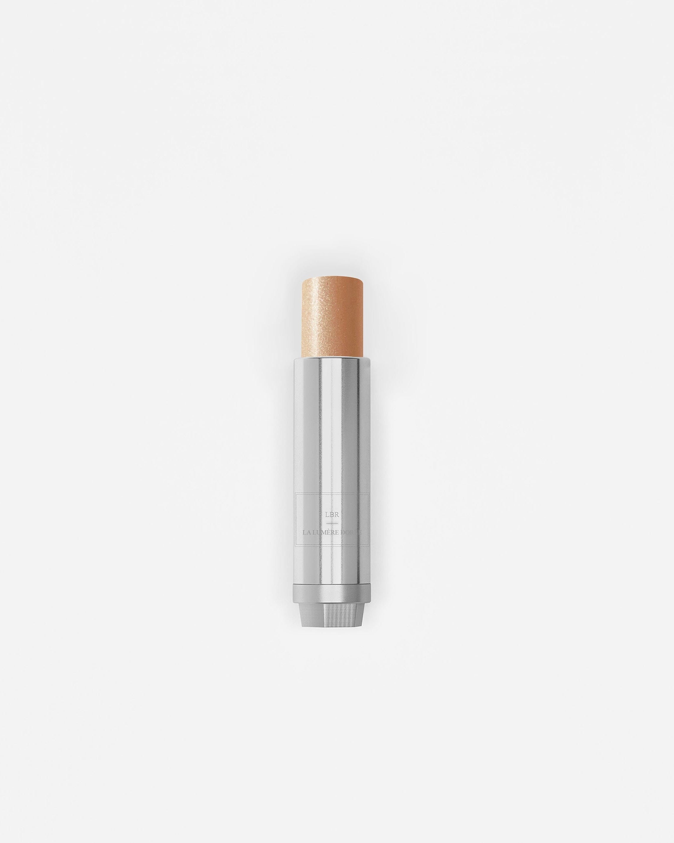 Stick enlumineur La Bouche Rouge Paris avec fini lumineux et naturel, présenté dans un emballage élégant.