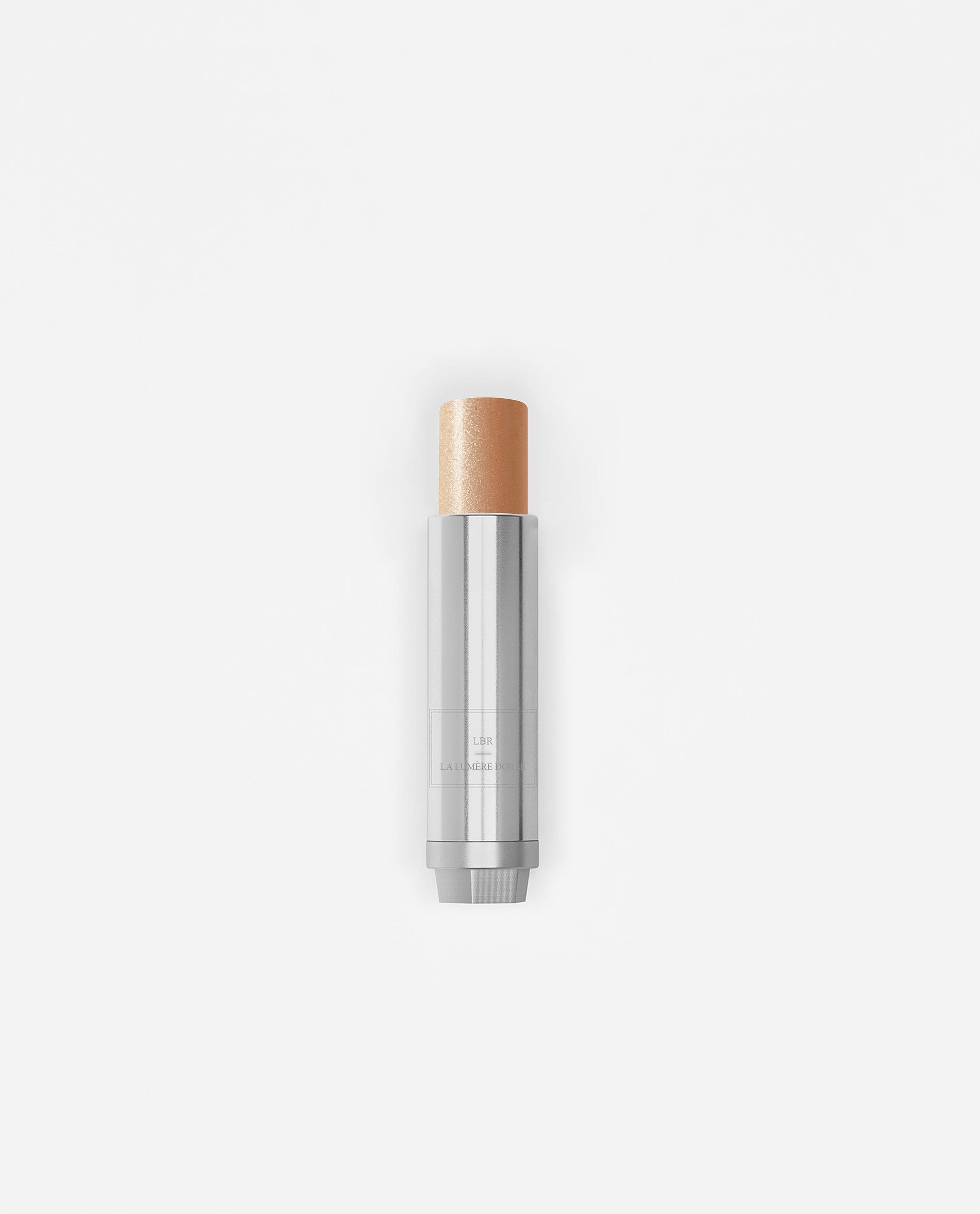 Stick enlumineur La Bouche Rouge Paris avec fini lumineux et naturel, présenté dans un emballage élégant.